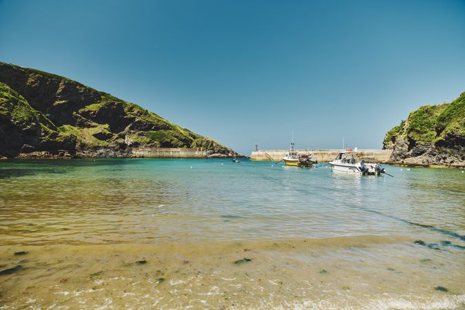 Fishing boats parked in a Cornwall cove surrounded by cliffs