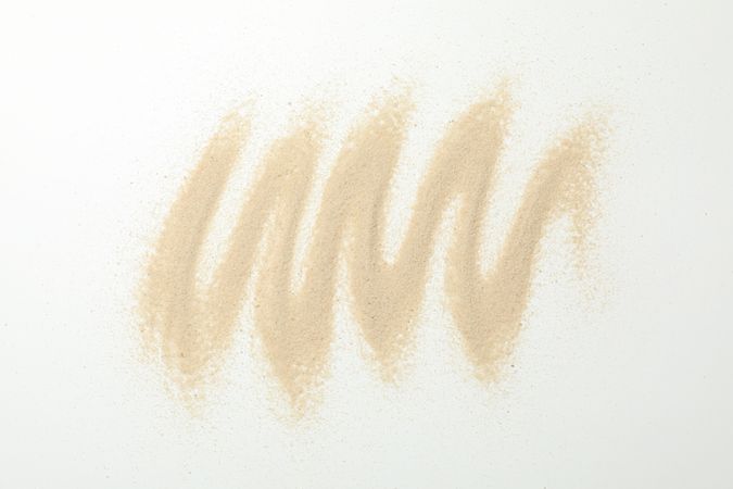 Dry sea sand on white background, top view