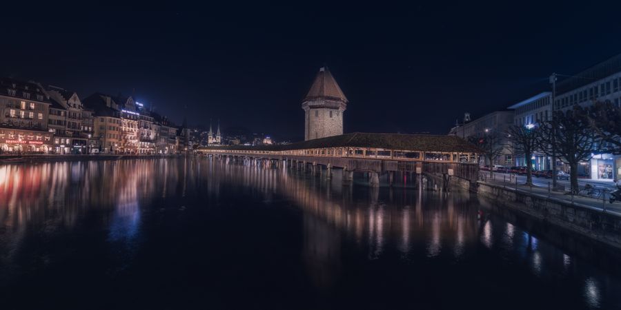 Illuminated buildings on city embankment in night
