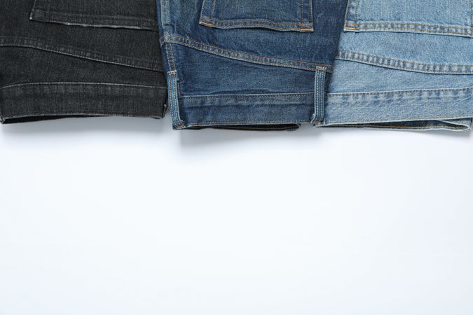 Flat lay with jeans on plain background, copy space