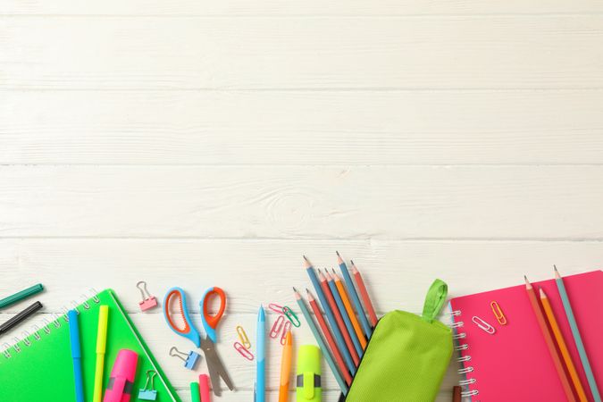 Flat lay composition with school supplies on wooden background, space for text