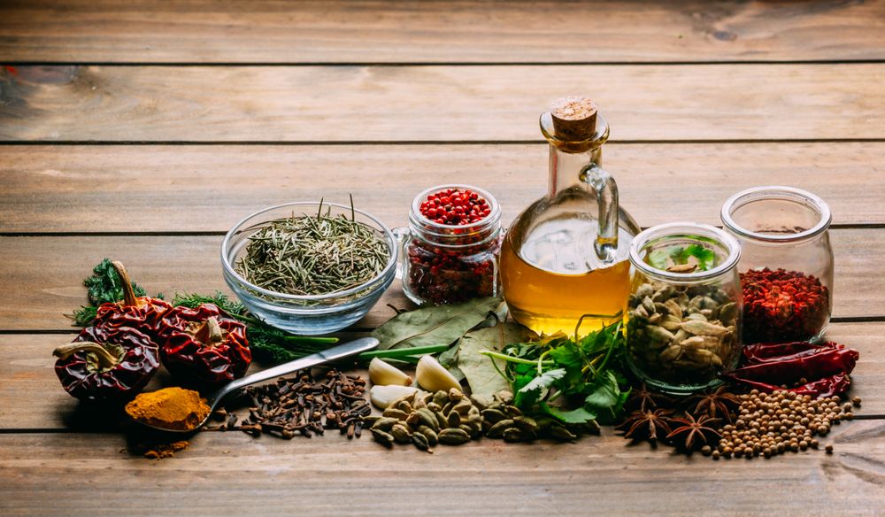 Spices and oil on table