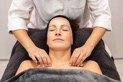Masseuse giving massage to client in beauty salon