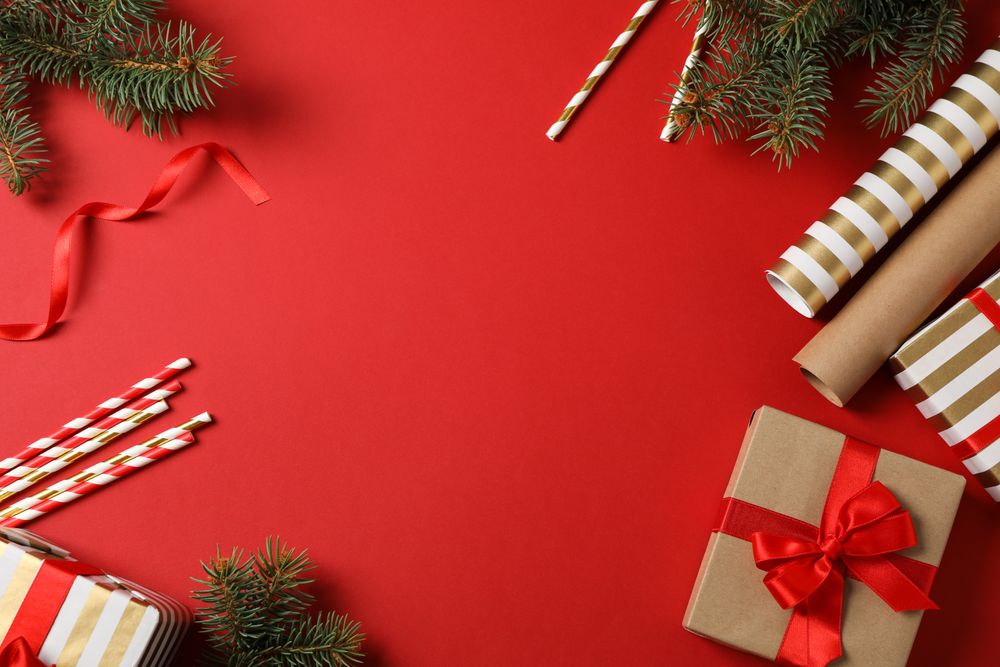 Composition with Christmas accessories on red background, space for text
