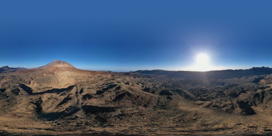 Sun shining above wild mountains