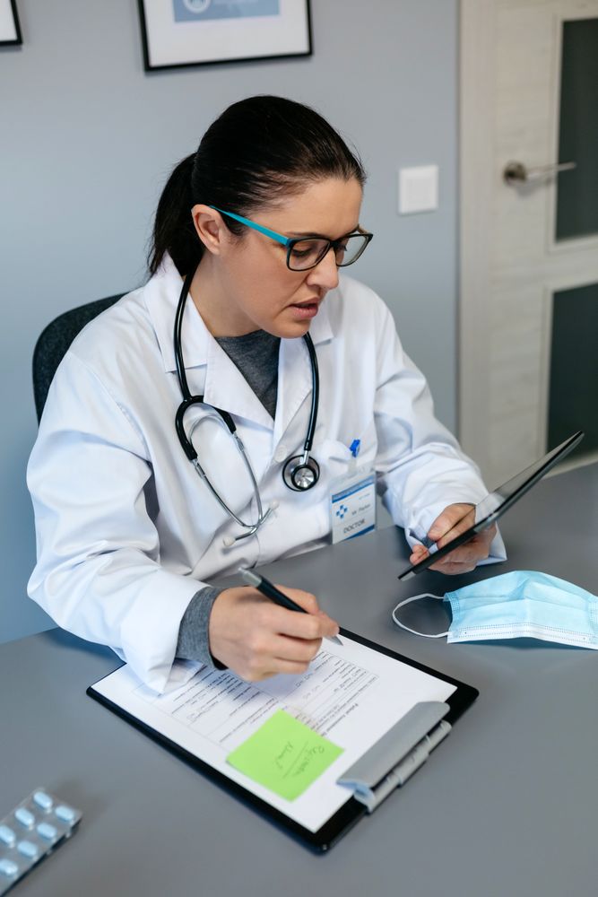 Female doctor doing online consultation with the tablet