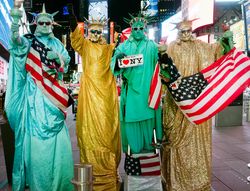 Statue of Liberty re-enactors pose Times Square, New York City, New York