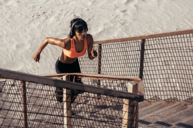 Fit woman exercising on the stairway on beach