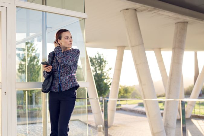 Businesswoman using smartphone outside building