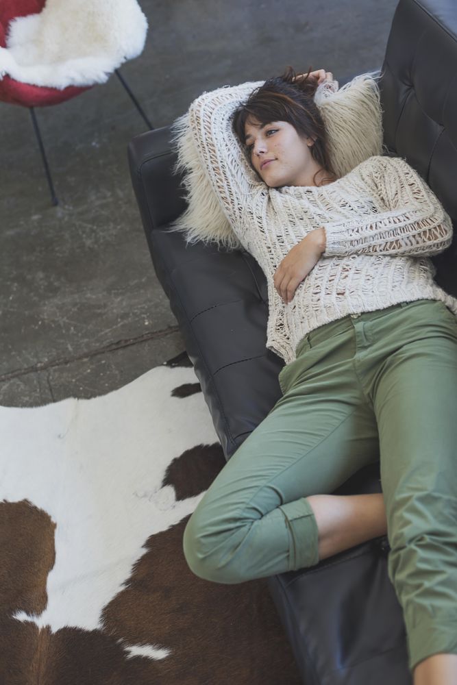 Looking down at female lying back on leather sofa