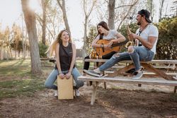 Cheerful musicians having fun in park