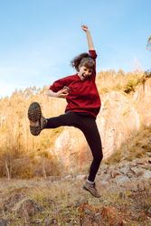 Young woman with smartphone dancing