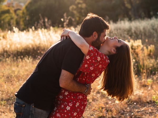 Young happy couple embracing in beautiful garden