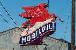 Vintage Mobil pegasus (flying horse) gas station insignia along a road in East Texas P5rp3b
