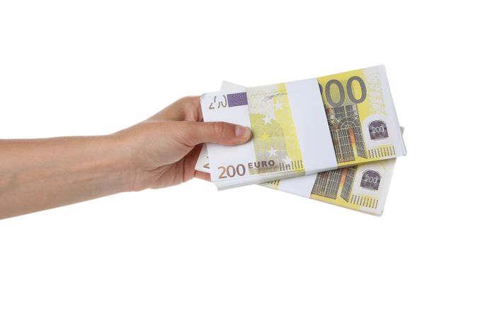 Female hand with Euro money isolated on light background