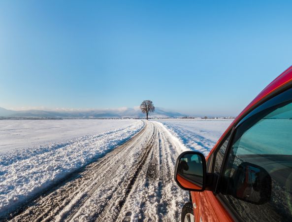 Snowy road in the fields of Alsace. Sunny winter day.
