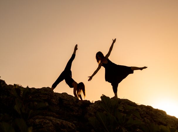 Women posing on hill in darkness