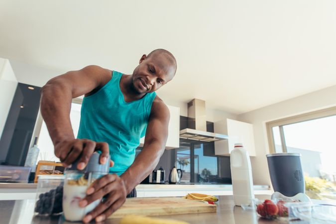 Man preparing milk shake in kitchen