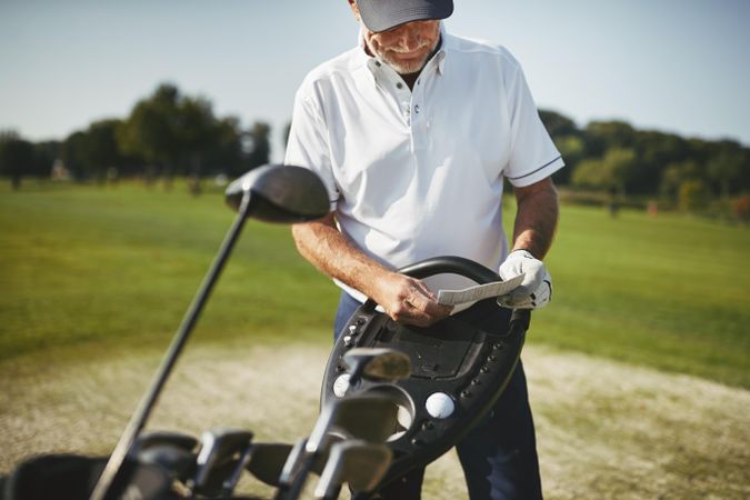 Man recording his score during a golf game