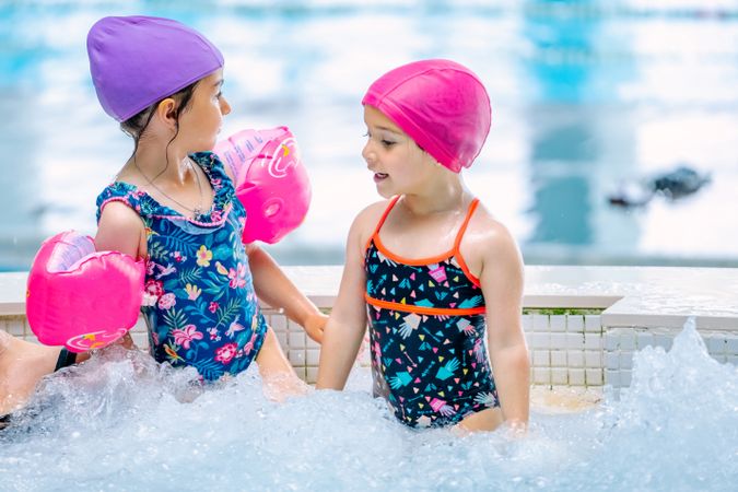 girls with water wings in swimming pool