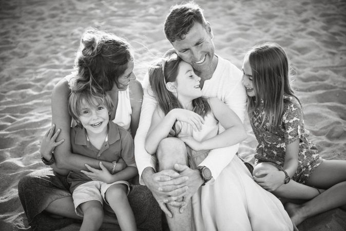 Beautiful happy family with playful children on beach