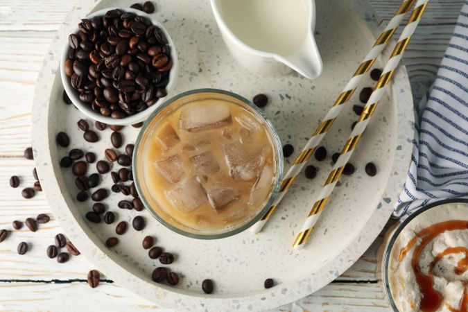 Composition with tray with ice coffee on wooden background