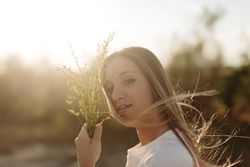 Young female looking at the camera with her hair blowing in the wind