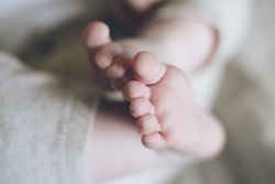 Charming cute baby feet and fingers of new born