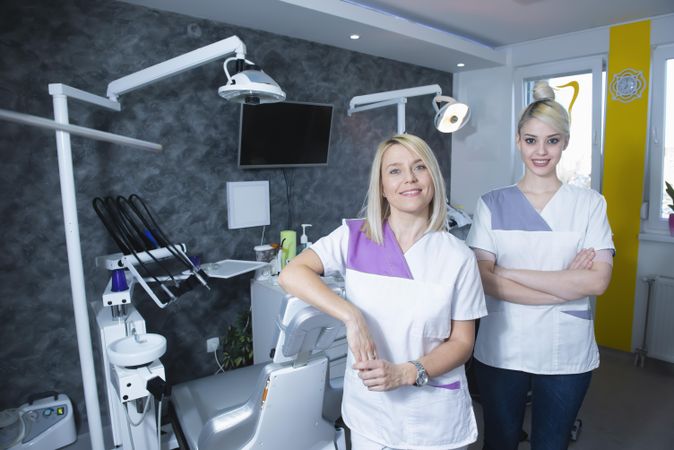 Two blonde female dentists in their bright office