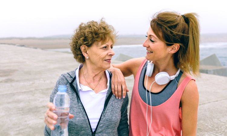 Mature sportswoman talking with female friend