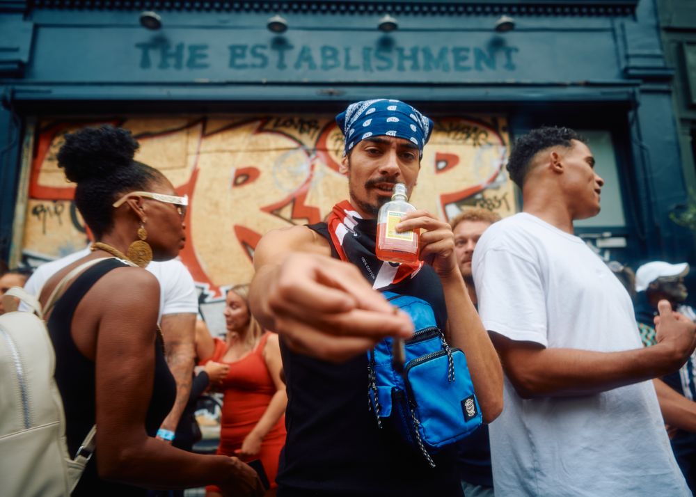 London, England, United Kingdom - August 28, 2022: Man offering camera a cigarette in crowd