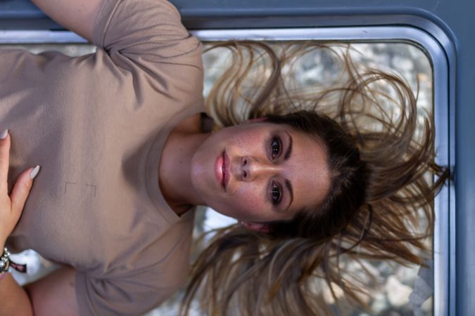 Military woman lying on window