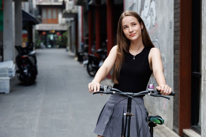 Portrait of woman tourist with bicycle travel in the city