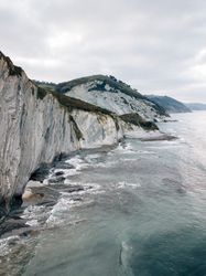 Sea waving near green hills