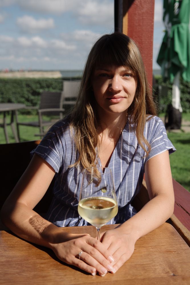 Young woman drinking wine in arbor
