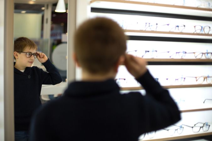 Young boy trying on glasses
