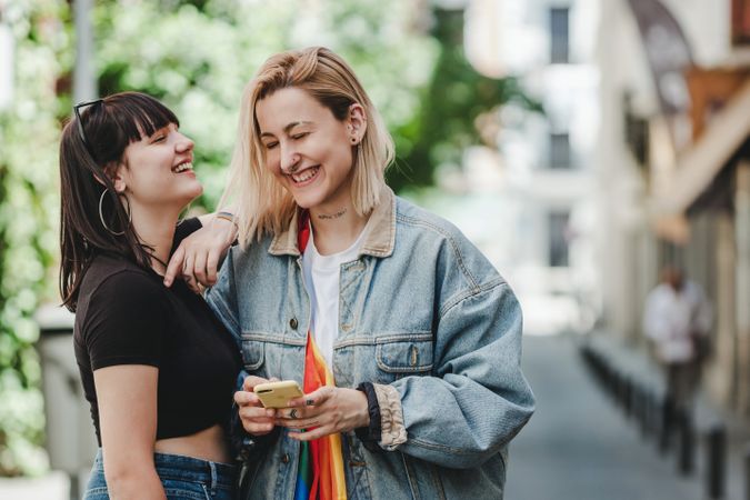 Lesbian couple on the mobile phone on street