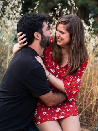 Young happy couple embracing in beautiful garden
