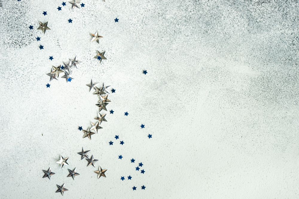 Festive Christmas card concept with silver star confetti decor