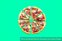 Homemade ham pizza minimalist on a green background 43NKV5