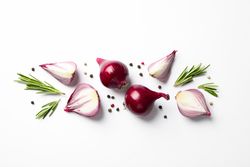Flat lay composition with red onion and spices on neutral background