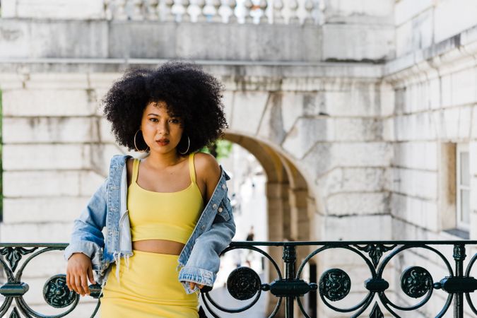 Stylish female leaning on railing outdoors
