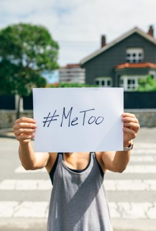 Woman showing poster with metoo hashtag