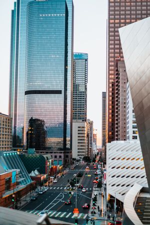 Cars on road near high rise buildings in Los Angeles, California, US at sunset