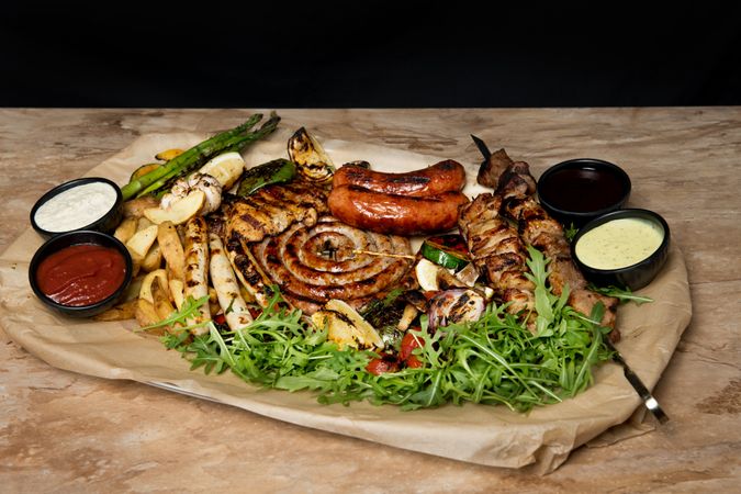 Sauces near fried meat and vegetables