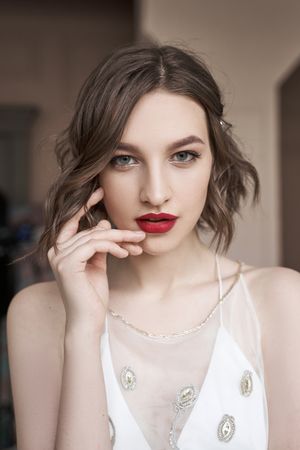 young confident woman with red lips looking at camera