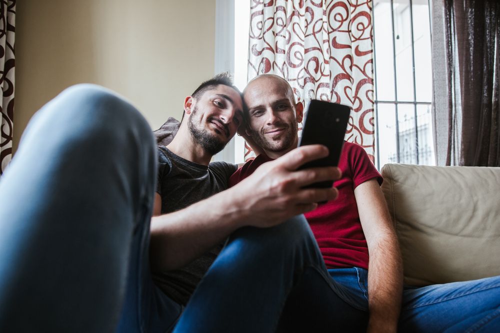 young gay couple at home