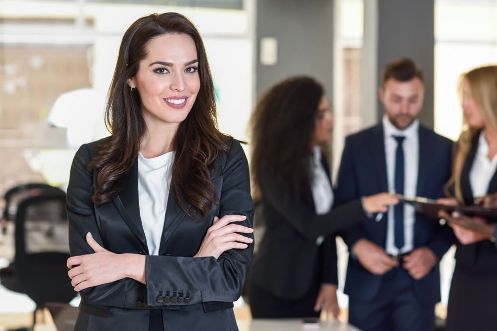 Woman standing in front of her colleagues in office