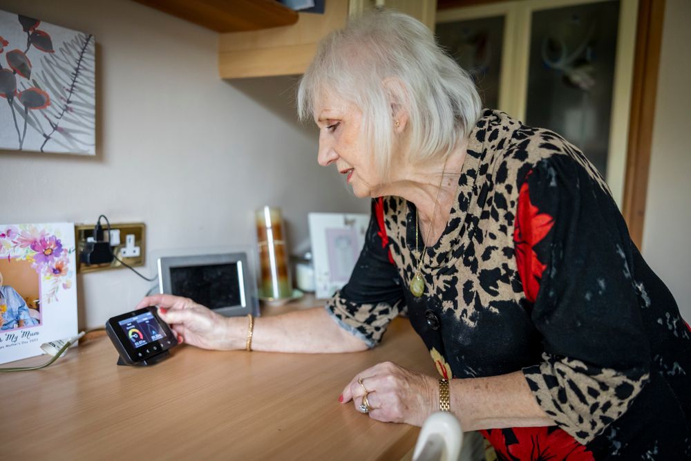 Woman adjusting smart meter