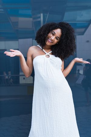 Smiling pregnant woman in long dress